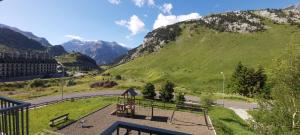 a view of a hill with a playground and a mountain at Apartamento Riglos Candanchu in Candanchú