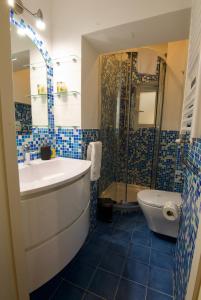 a bathroom with a sink and a shower and a toilet at Major sisters, holiday home in the heart of Rome in Rome