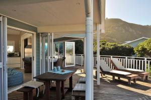 a porch with a table and chairs on a house at Glentana Beach Rental in Groot Brak Rivier