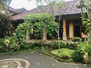 a house with a garden in front of it at Puri Mandala Kaleran in Ubud