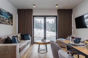 a living room with a couch and a table at Smrekowa Ostoja in Poronin