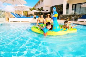 a group of children playing in a swimming pool at MARITIM Resort & Spa, Turtle Bay in Balaclava