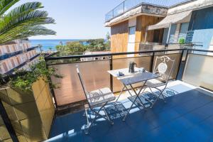 a balcony with a table and two chairs on it at Mauri Dolce & Vita Luxury House and Apartment in the town center in Maiori