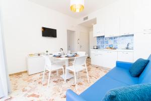 a living room with a blue couch and a table at Mauri Dolce & Vita Luxury House and Apartment in the town center in Maiori