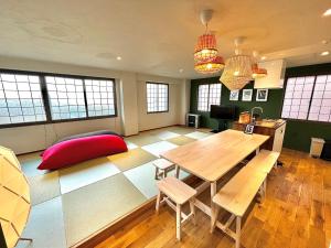 a large room with a table and chairs and windows at Swiss Inn in Sapporo