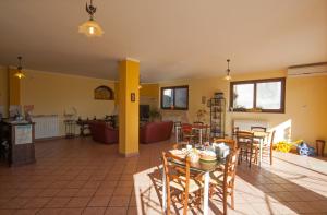 a living room with a table and chairs at La Porta Dell'Etna - Nicolosi in Nicolosi