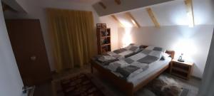 1 dormitorio con 1 cama y mesita de noche con lámpara en Ravne weekend house, en Visoko
