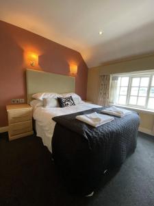 a hotel room with two beds with towels on them at The Windmill Inn 