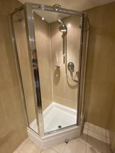 a shower with a glass enclosure in a bathroom at The Windmill Inn 