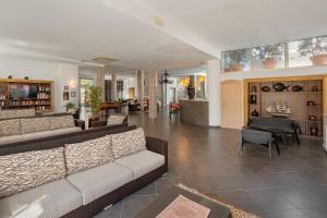 a living room with a couch and a table at The Pelican Beach Resort & SPA - Adults Only in Olbia