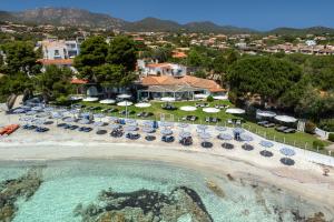 an aerial view of a beach with chairs and umbrellas at The Pelican Beach Resort & SPA - Adults Only in Olbia