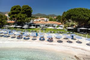 an aerial view of a beach with chairs and umbrellas at The Pelican Beach Resort & SPA - Adults Only in Olbia