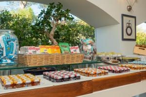 a display case with a bunch of different types of food at The Pelican Beach Resort & SPA - Adults Only in Olbia