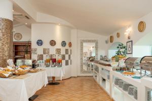 a bakery with two tables in a room at The Pelican Beach Resort & SPA - Adults Only in Olbia