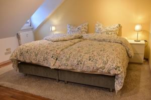 a bedroom with a large bed with a comforter and pillows at Ferienwohnung Happynest in Birresborn
