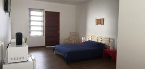 a bedroom with a bed and a television in it at Bij BRAKKE in Paramaribo