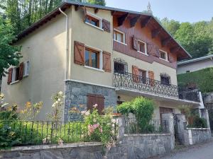 a large house with a fence in front of it at Le Chalet des O in Saint-Lary-Soulan