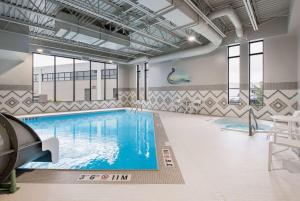 a pool in a building with a swimming pool at Wyndham Garden Winnipeg Airport in Winnipeg