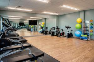 a gym with a lot of treadmills and exercise bikes at Wyndham Garden Winnipeg Airport in Winnipeg