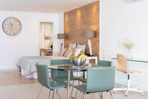 a bedroom with a bed and a table and chairs at Rooms & Suites Loft 2G Deluxe Edition Arrecife in Arrecife