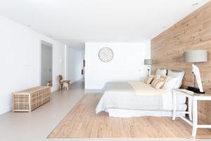 a white bedroom with a bed and a desk at Rooms & Suites Loft 2G Deluxe Edition Arrecife in Arrecife
