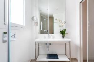 a bathroom with a sink and a mirror at Rooms & Suites Loft 2G Deluxe Edition Arrecife in Arrecife +26 photos