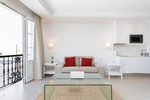 a living room with a couch and a table at Rooms & Suites Loft 2G Deluxe Edition Arrecife in Arrecife