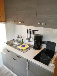 a kitchen counter with a sink and a stove at Haus Fessel - Helenenruh in Elend
