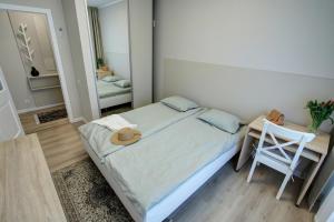 a bedroom with a bed with a hat on it at Alve Apart Hotel in Jūrmala