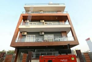 a tall building with a balcony on top of it at Hotel Shree Shyam By WB Inn in Gurgaon