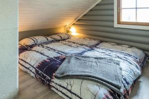 a bedroom with a bed in a attic at Kieppi, open your door and enjoy the wilderness in Utsjoki