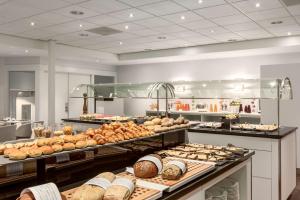a bakery with lots of different types of bread at NH Utrecht in Utrecht