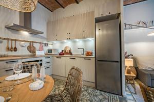 a kitchen with a table with chairs and a refrigerator at Habitat Apartments Sweet Sagrada Familia in Barcelona
