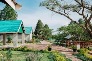 a path leading to a house with a blue roof at Gosheni Villas in White River