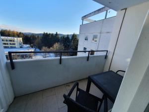 a balcony with a table and chairs on a building at Gipfelstürmer in Hahnenklee-Bockswiese