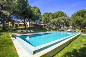 a swimming pool in the yard of a house at The Manor House by The Getaway Collection in Grândola