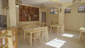 a dining room with wooden tables and chairs at Speed 8 Inn Moalboal in Moalboal