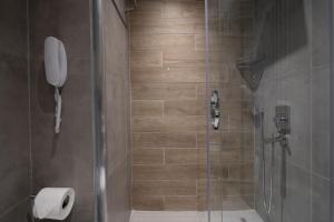 a bathroom with a shower with a phone on the wall at Green Garden Resort & Spa Hotel in Alanya