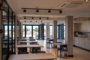 a row of tables and chairs in a restaurant at Arena Suites in Mar del Plata