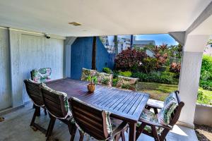 a wooden table and chairs on a patio at JMK at 49 LaPirogue - Families only in Ballito
