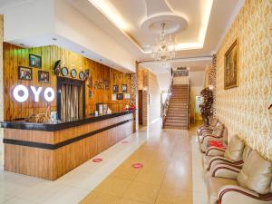 a lobby of an ovo store with couches at SUPER OYO Capital O 540 Esther Hotel in Balige