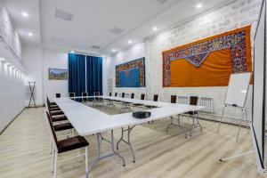 a conference room with a white table and chairs at Olive hotel Kochkor in Kochkorka