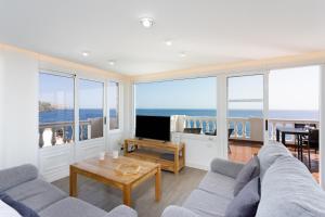 a living room with a view of the ocean at Over the Ocean in Candelaria