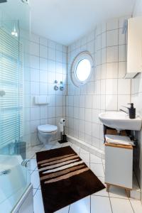 a white bathroom with a sink and a toilet at Mercedes I Stuttgart I Kitchen I Home Office I Parkplatz in Böblingen