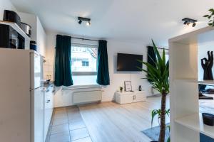 a living room with a refrigerator and a window at Mercedes I Stuttgart I Kitchen I Home Office I Parkplatz in Böblingen +3 photos