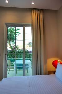 a bedroom with a bed and a view of a patio at Hotel Luxury in Ksamil