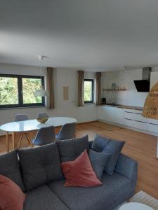 a living room with a couch and a table at Ferienwohnungen am Jura in Weißenburg in Bayern