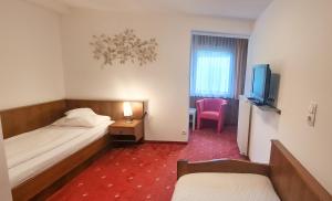 Un pat sau paturi într-o cameră la Pension Seeblick