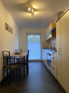 a kitchen with a table and a table and chairs at Gästewohnung 3 in Oschersleben