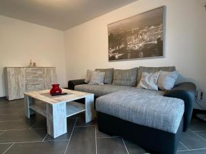 a living room with a couch and a table at Gästewohnung 3 in Oschersleben +1 photo